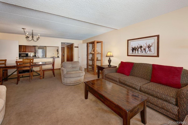 carpeted living room featuring a chandelier and a textured ceiling