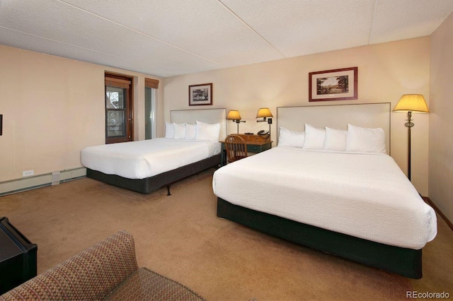 carpeted bedroom featuring a textured ceiling and a baseboard heating unit