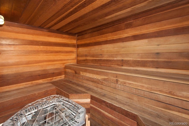 view of sauna / steam room featuring wooden walls and wooden ceiling