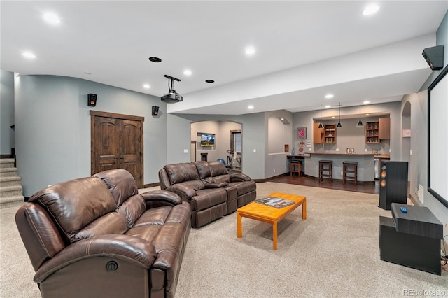 living area with recessed lighting, arched walkways, stairway, bar, and carpet floors