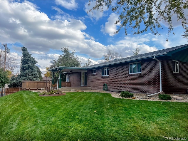 rear view of house with a lawn and a patio area