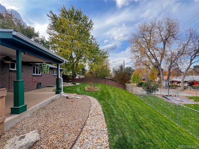 view of yard featuring ceiling fan