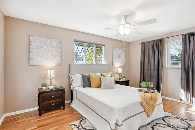 bedroom with light wood-type flooring and ceiling fan