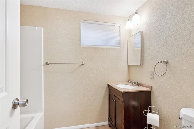 full bathroom featuring toilet, vanity, and  shower combination