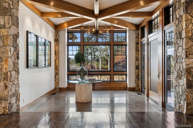 interior space with beam ceiling, baseboards, and hardwood / wood-style floors