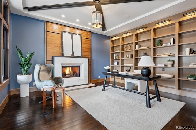 office area with a fireplace with flush hearth, baseboards, and dark wood finished floors