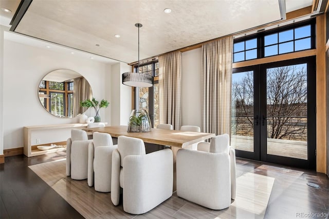 dining room with baseboards, french doors, light wood-style flooring, and recessed lighting