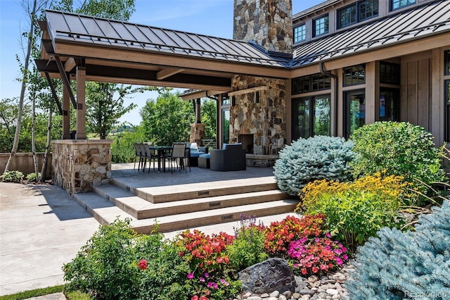 view of patio / terrace with an outdoor stone fireplace and outdoor dining area