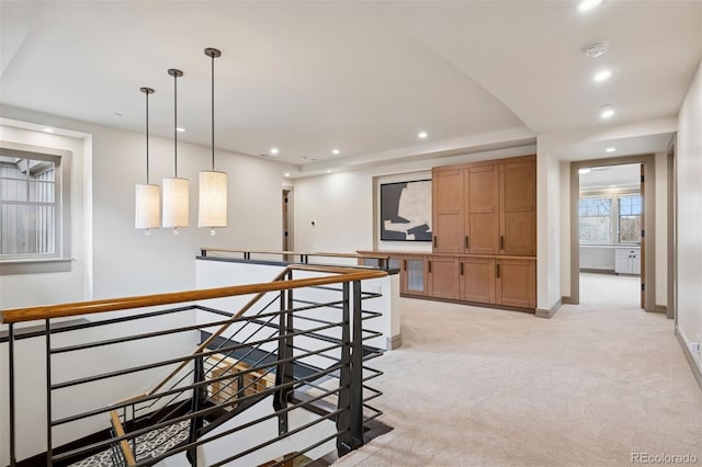 hallway with recessed lighting, baseboards, light colored carpet, and an upstairs landing