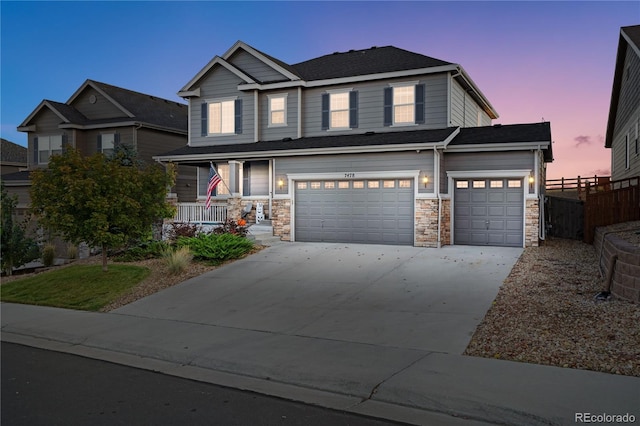 craftsman inspired home featuring a garage and a porch