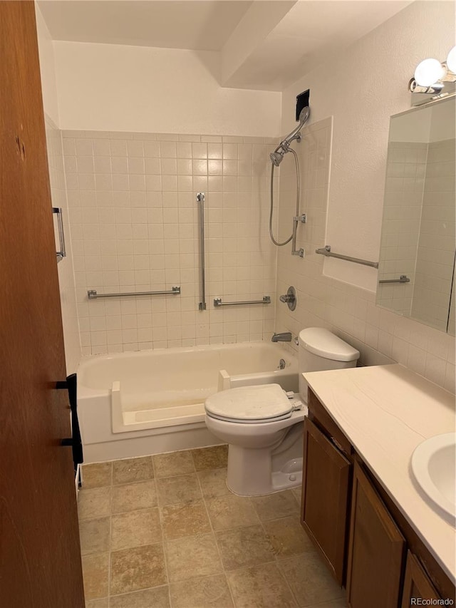 full bathroom with vanity, toilet, tile walls, and bathing tub / shower combination