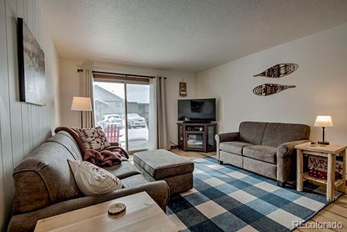 1143 Straight Creek Dr Unit H103, Dillon, CO 80435 - living area featuring a textured ceiling