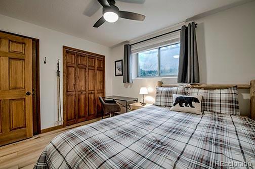 1143 Straight Creek Dr Unit H103, Dillon, CO 80435 - bedroom with light wood-type flooring, a closet, and ceiling fan