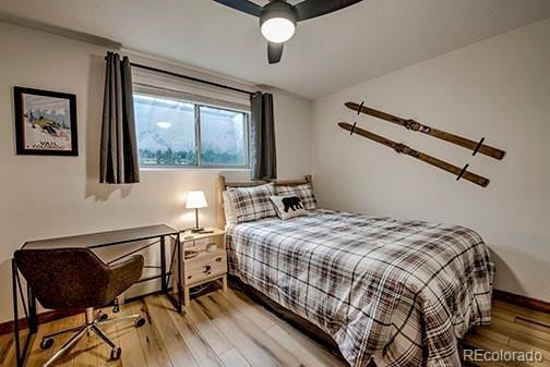 1143 Straight Creek Dr Unit H103, Dillon, CO 80435 - bedroom featuring light wood-style flooring, a ceiling fan, and baseboards