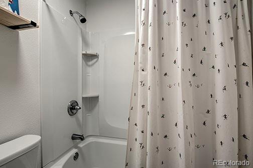 1143 Straight Creek Dr Unit H103, Dillon, CO 80435 - bathroom with shower / bath combination with curtain and toilet