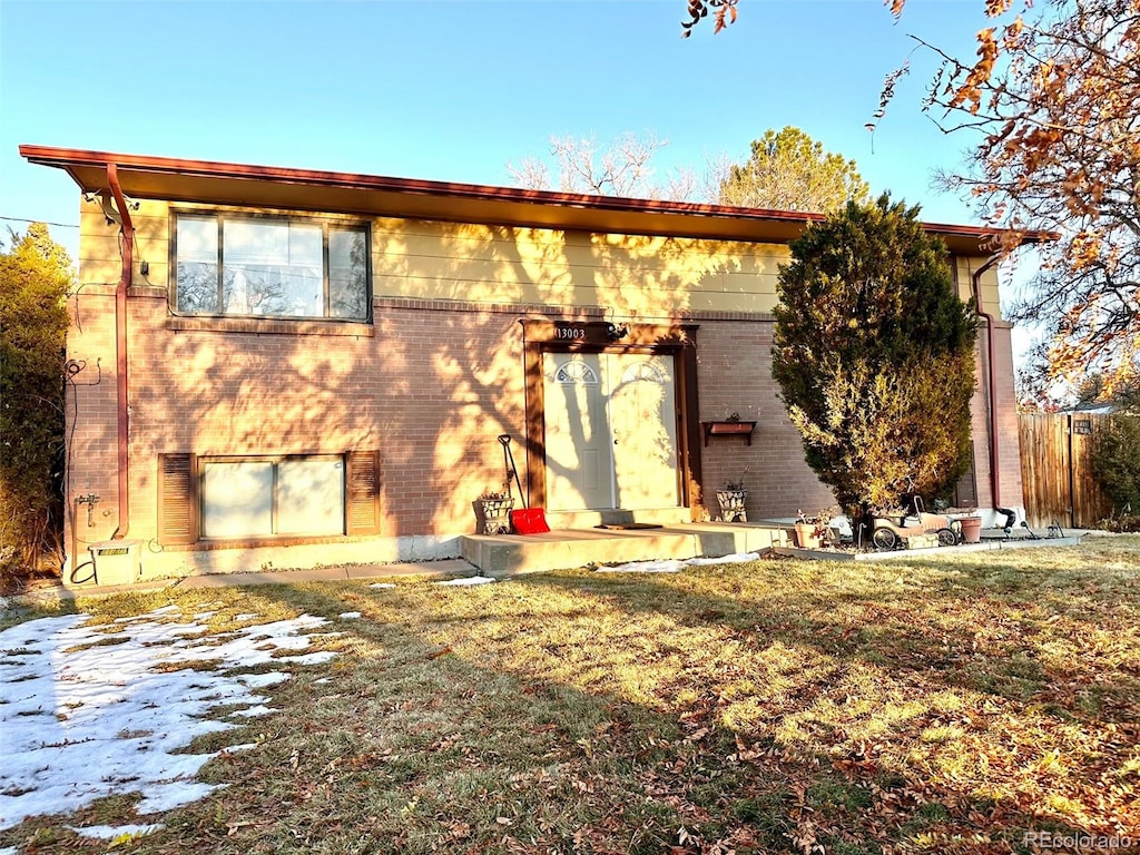 rear view of property with a yard