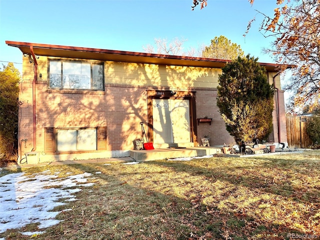 rear view of property with a yard