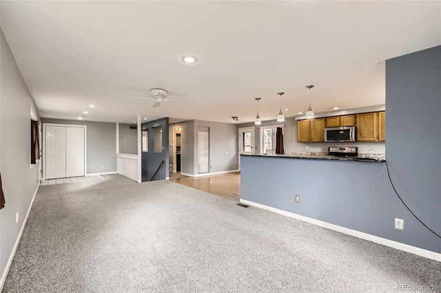 unfurnished living room featuring light colored carpet, baseboards, a ceiling fan, and recessed lighting