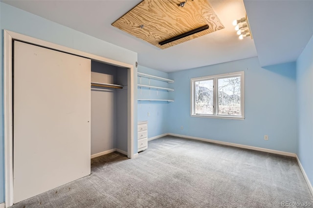 unfurnished bedroom featuring carpet floors, a closet, and baseboards