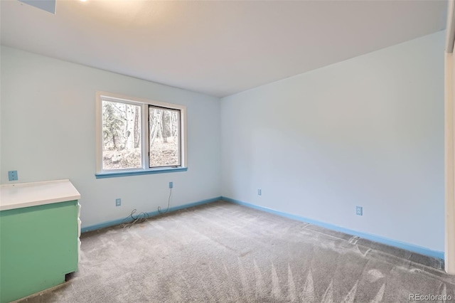 spare room with carpet floors and baseboards