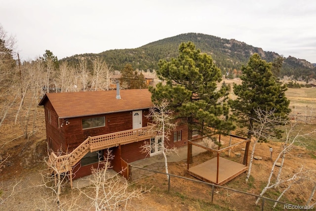 rear view of house with a patio area, stairway, a deck with mountain view, and fence