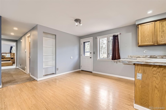 foyer entrance with baseboards, light wood-type flooring, and recessed lighting