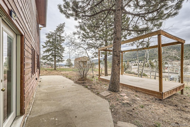 view of yard featuring a patio area and a deck