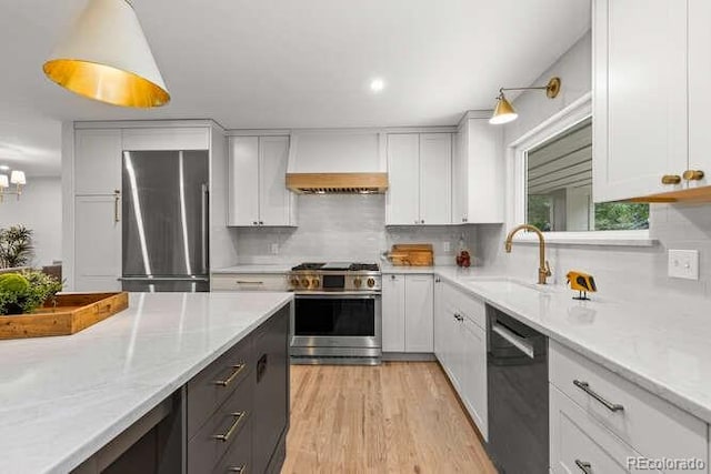 4 Doral Ln, Littleton, CO 80123 - kitchen with stainless steel appliances, custom range hood, tasteful backsplash, white cabinetry, and recessed lighting