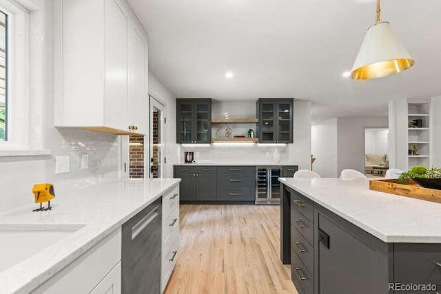 4 Doral Ln, Littleton, CO 80123 - kitchen with dishwasher, white cabinets, light wood finished floors, glass insert cabinets, and open shelves