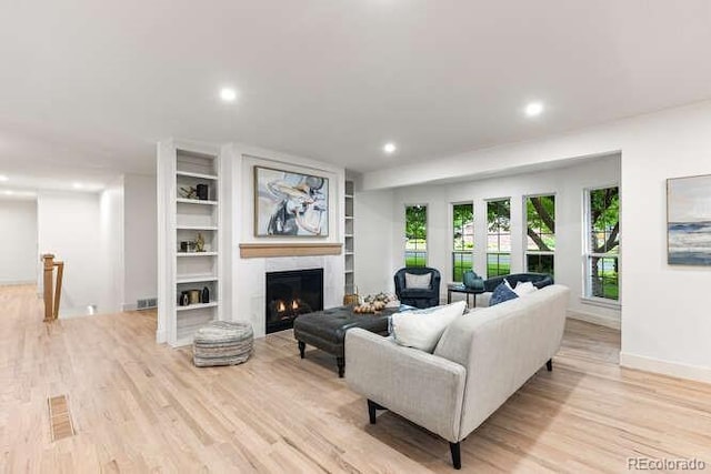 4 Doral Ln, Littleton, CO 80123 - living room with light wood-style floors, recessed lighting, a warm lit fireplace, and built in features