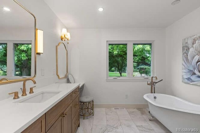 4 Doral Ln, Littleton, CO 80123 - bathroom featuring a soaking tub, vanity, marble finish flooring, and recessed lighting