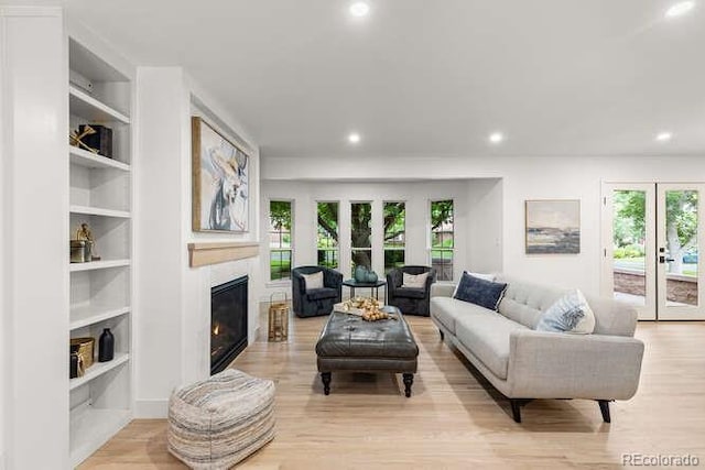 4 Doral Ln, Littleton, CO 80123 - living area with healthy amount of natural light, a glass covered fireplace, recessed lighting, and light wood-style flooring
