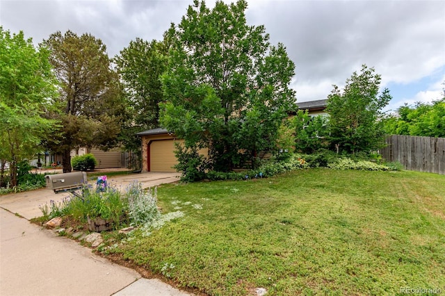 18206 E Loyola Dr, Aurora, CO 80013 - view of yard with a garage and concrete driveway