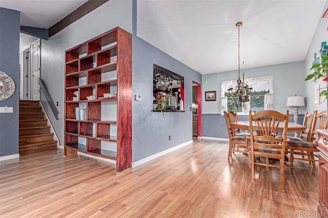 18206 E Loyola Dr, Aurora, CO 80013 - dining space featuring wood finished floors, a chandelier, and stairway