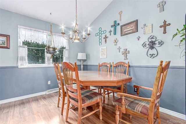 18206 E Loyola Dr, Aurora, CO 80013 - dining space featuring a chandelier, vaulted ceiling, and wood finished floors