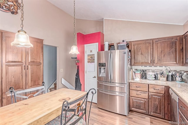 18206 E Loyola Dr, Aurora, CO 80013 - kitchen featuring appliances with stainless steel finishes, light wood-style floors, decorative light fixtures, light stone counters, and high vaulted ceiling