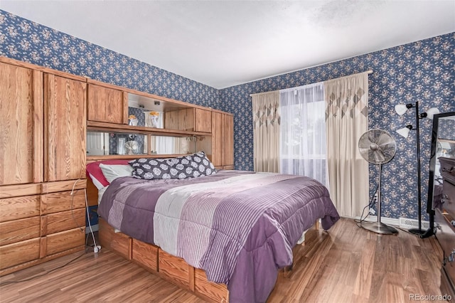 18206 E Loyola Dr, Aurora, CO 80013 - bedroom featuring wallpapered walls and wood finished floors
