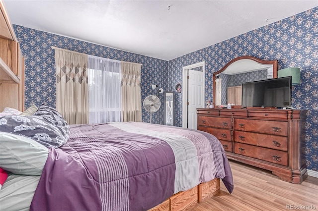 18206 E Loyola Dr, Aurora, CO 80013 - bedroom featuring wallpapered walls and wood finished floors