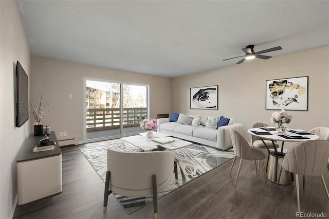 living room with dark hardwood / wood-style flooring, ceiling fan, a textured ceiling, and baseboard heating