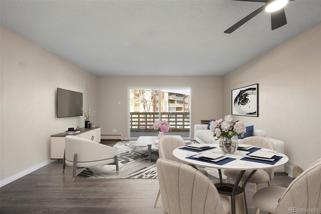 dining space with hardwood / wood-style flooring, a textured ceiling, ceiling fan, and baseboard heating