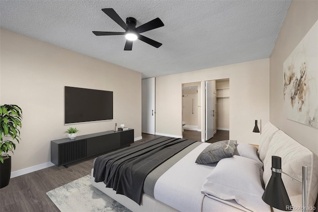 bedroom featuring ceiling fan, dark hardwood / wood-style floors, ensuite bathroom, and a textured ceiling