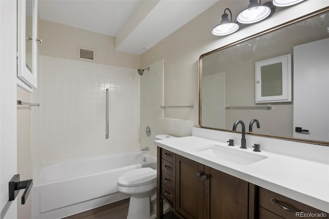 full bathroom featuring vanity, wood-type flooring, toilet, and washtub / shower combination