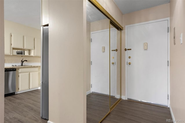 hallway featuring sink and dark wood-type flooring