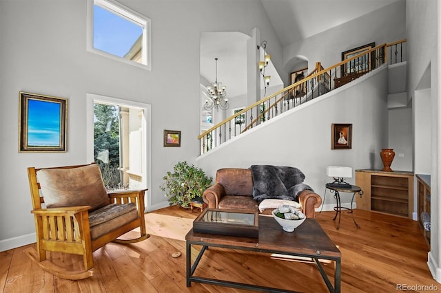 1425 Autumnwood Ln, Evergreen, CO 80439 - sitting room featuring a towering ceiling, baseboards, stairway, and wood finished floors