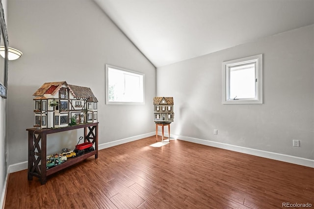 1425 Autumnwood Ln, Evergreen, CO 80439 - living area with plenty of natural light, baseboards, wood finished floors, and lofted ceiling