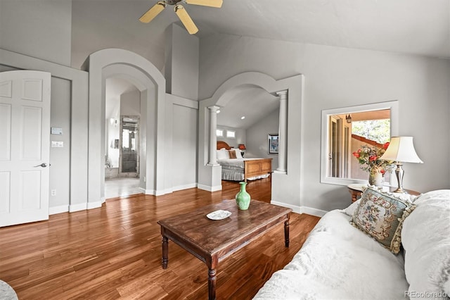 1425 Autumnwood Ln, Evergreen, CO 80439 - living room featuring decorative columns, arched walkways, a ceiling fan, wood finished floors, and high vaulted ceiling