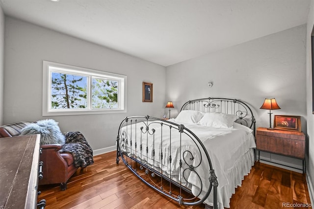 1425 Autumnwood Ln, Evergreen, CO 80439 - bedroom featuring baseboards and wood finished floors