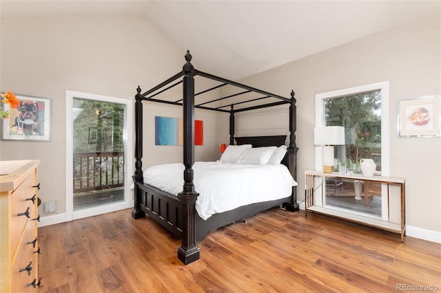 1425 Autumnwood Ln, Evergreen, CO 80439 - bedroom featuring access to outside, multiple windows, wood finished floors, and lofted ceiling