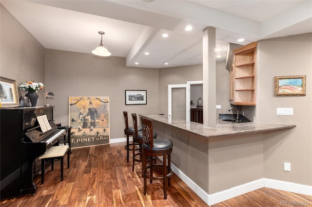 1425 Autumnwood Ln, Evergreen, CO 80439 - kitchen featuring recessed lighting, dark wood-type flooring, a breakfast bar, a peninsula, and light stone countertops