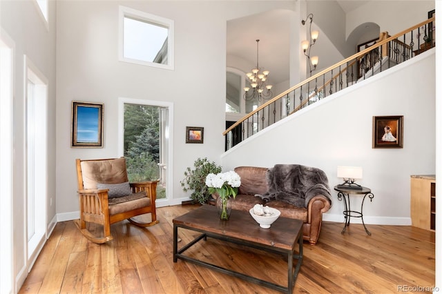1425 Autumnwood Ln, Evergreen, CO 80439 - living area with a towering ceiling, hardwood / wood-style flooring, stairs, and a chandelier